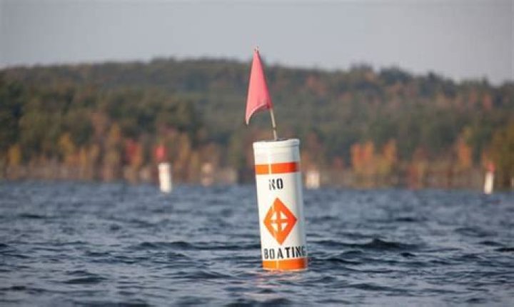 white buoy with orange square and black lettering